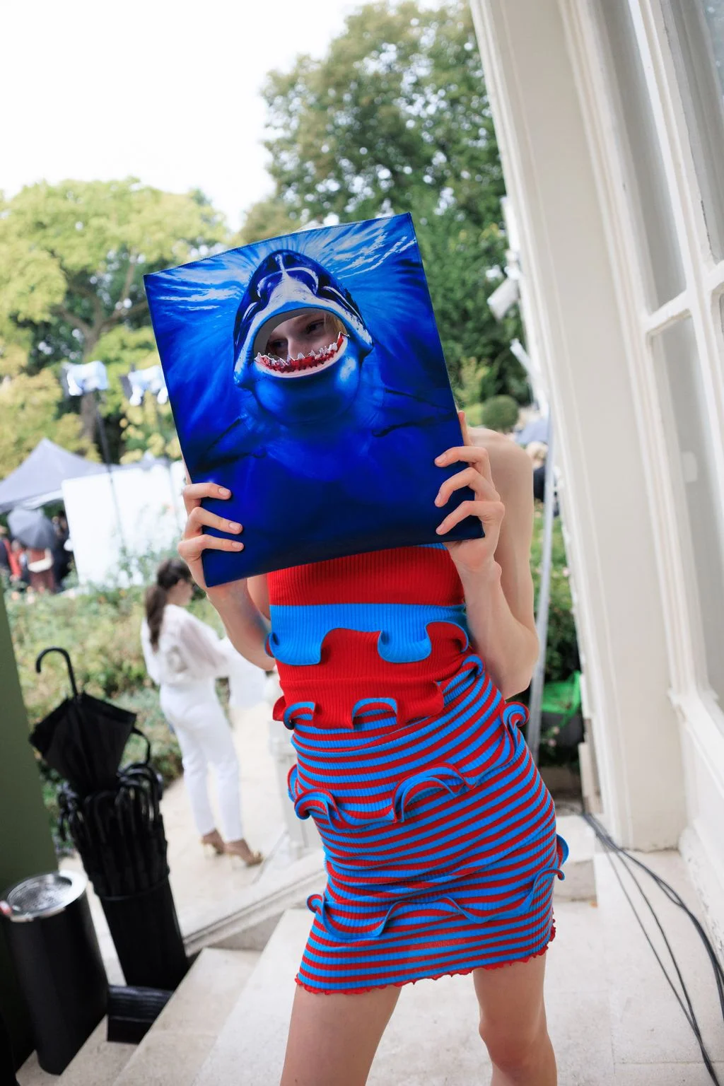 Image may contain Clothing Costume Person Adult Face Head Photography Portrait Dress Formal Wear and TShirt