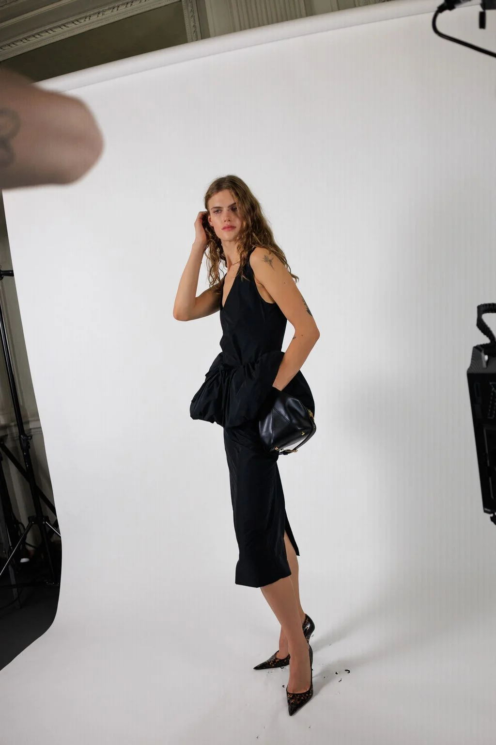 Image may contain Adult Person Photography Electronics Camera Clothing Dress Photoshoot Accessories and Bag