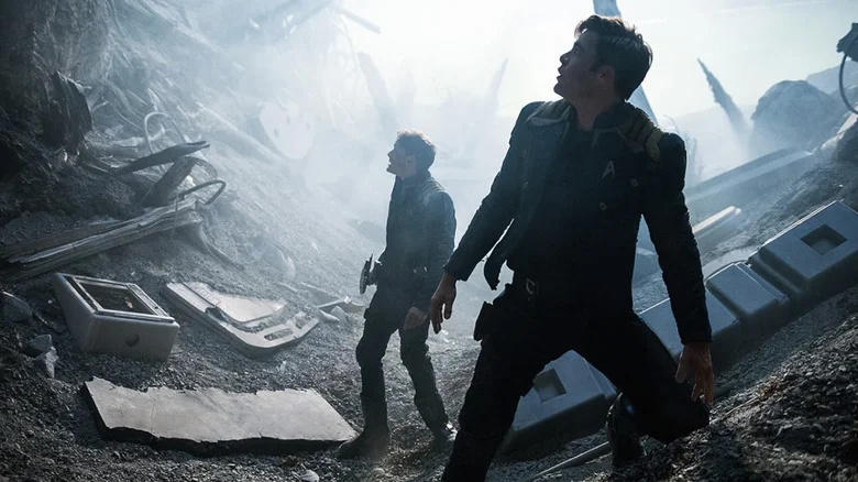 Chekov and Kirk looking up at something amid the wreckage of a crash in Star Trek Beyond