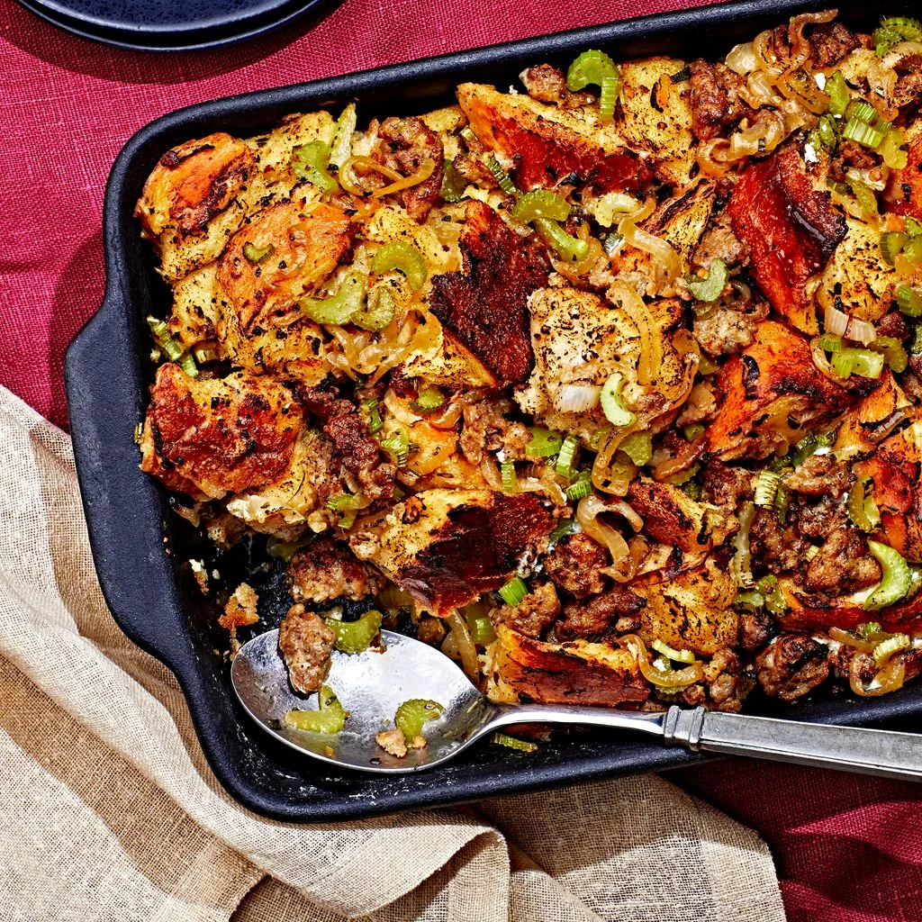 Makeahead stuffing in a casserole dish with a corner scoop removed.