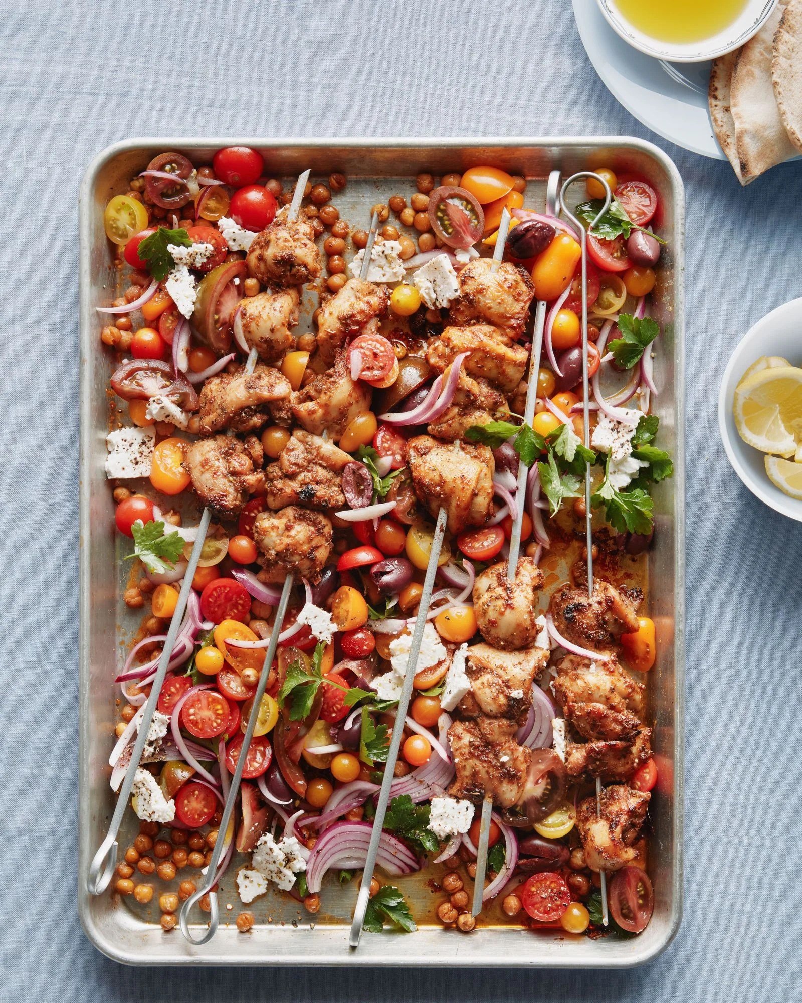 Boneless skinless chicken thighs tossed in oregano cumin sugar black pepper and salt and roasted on skewers on a sheet...
