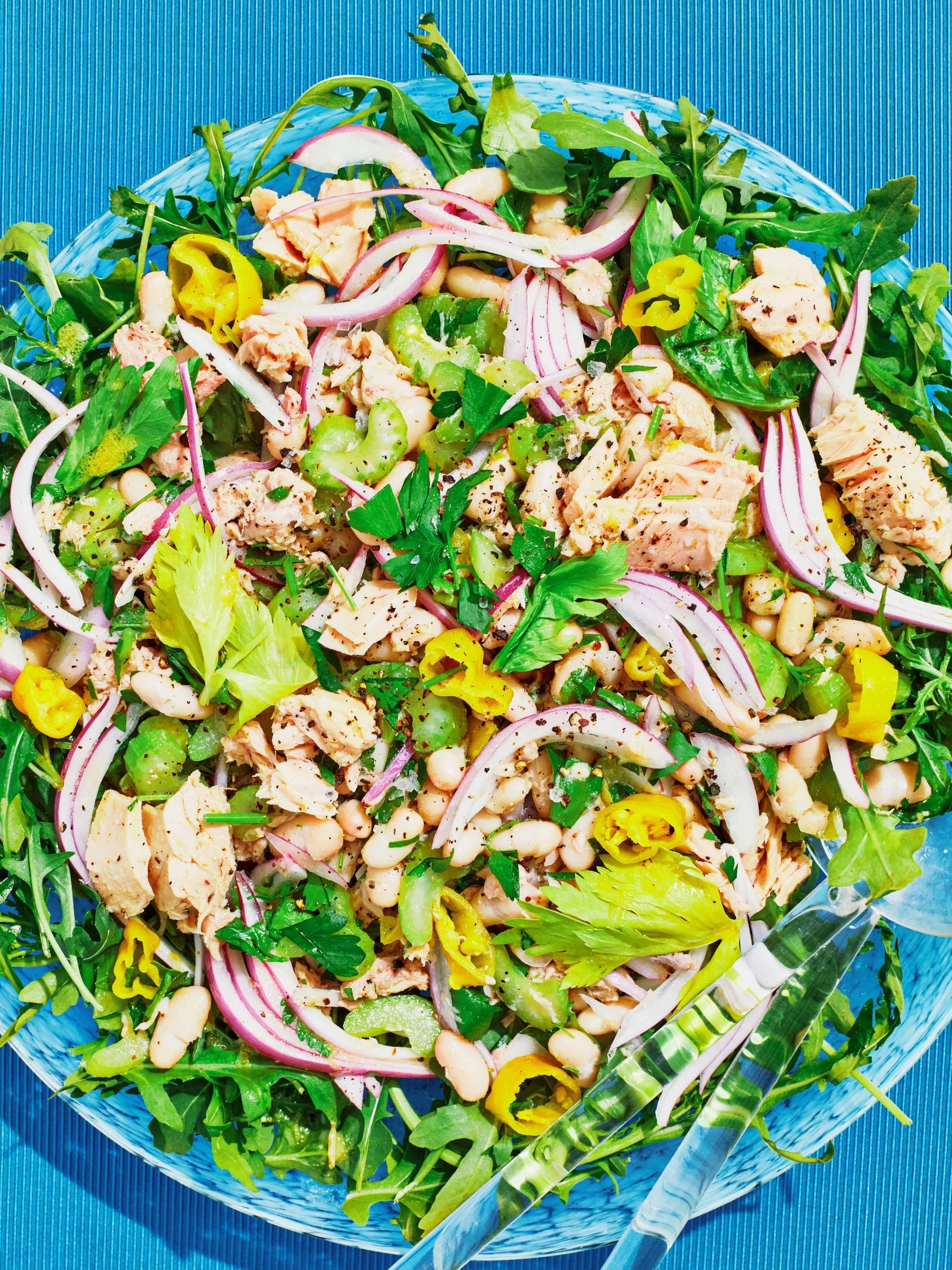 Sliced red onions oilpacked tuna celery stalks cannellini and Pepperoncini peppers tossed in a dressing of olive oil...