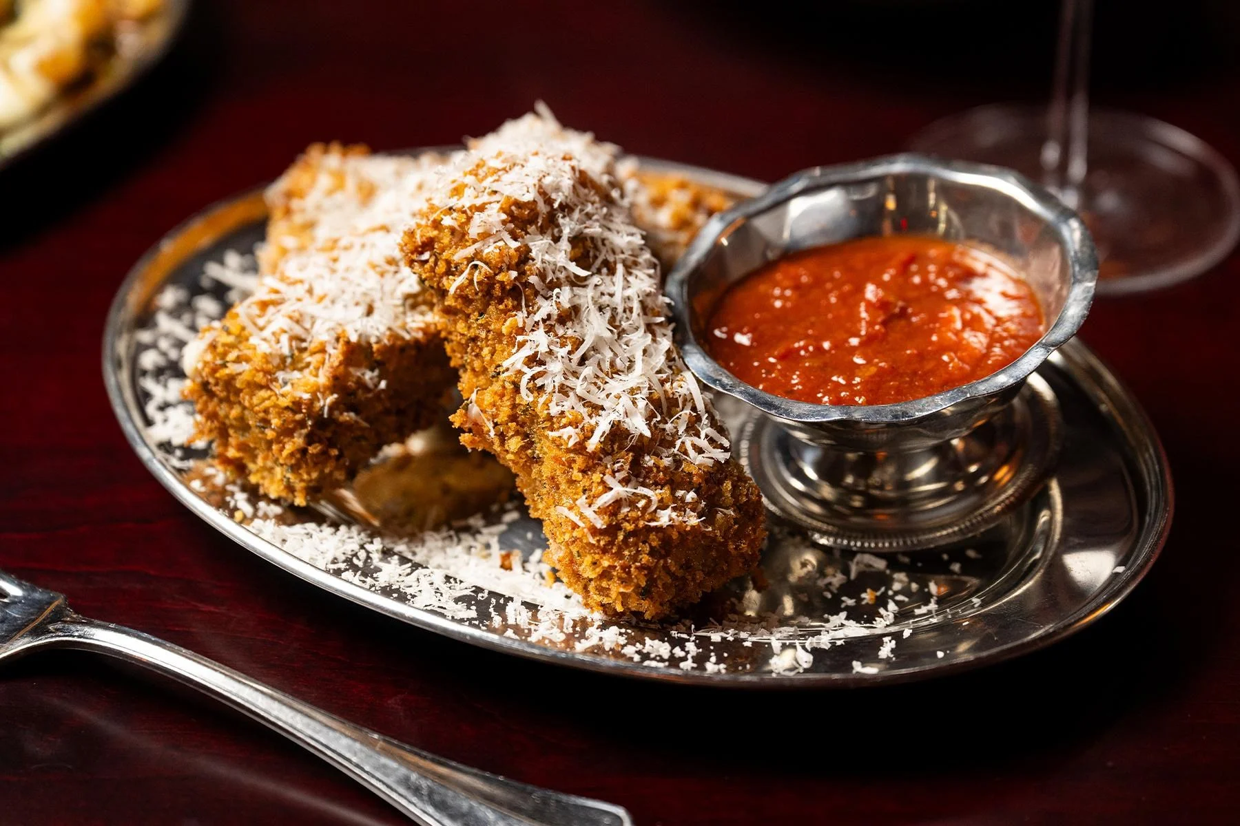 a plate of mozzarella sticks and marinara sauce from the new york city restaurant floradora