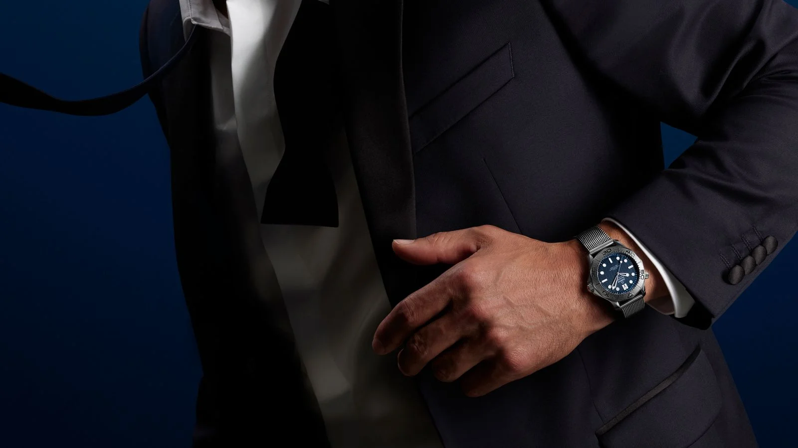 Image may contain Clothing Formal Wear Suit Body Part Finger Hand Person Tuxedo Adult Accessories and Tie
