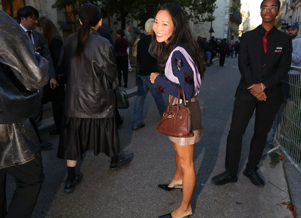 Image may contain Accessories Bag Handbag Purse Person Teen Adult Clothing Footwear Shoe Coat Head and Face