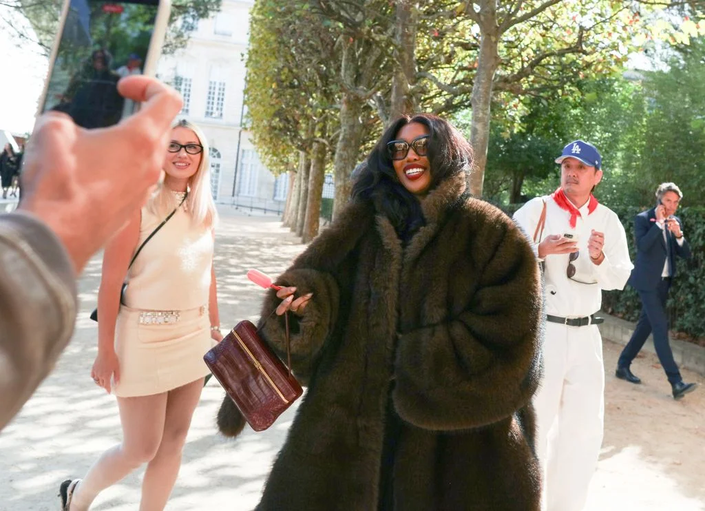 Image may contain SZA Accessories Bag Handbag Clothing Coat Face Head Person Photography Portrait and Adult