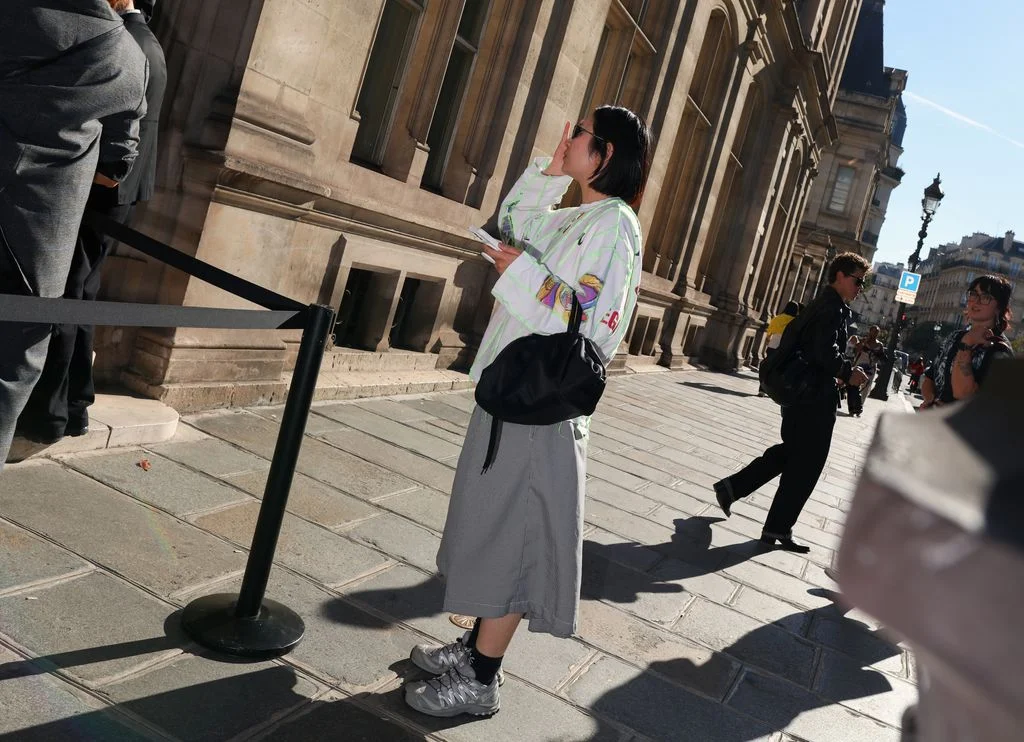 Image may contain Clothing Footwear Shoe Skirt Adult Person Pedestrian City Accessories Bag and Handbag
