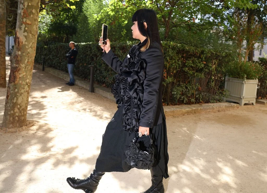 Image may contain Clothing Coat Adult Person Dress Footwear Shoe Jacket Accessories Bag Handbag and Black Hair