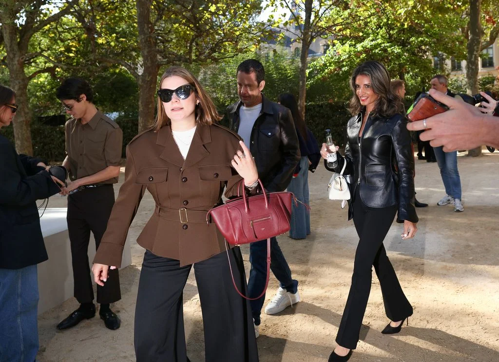 Image may contain Accessories Bag Handbag Clothing Coat Jacket Purse Adult Person Blazer Pants and Walking