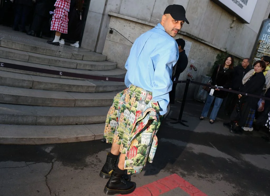 Image may contain Clothing Skirt Tartan Adult Person Footwear Shoe and Kilt