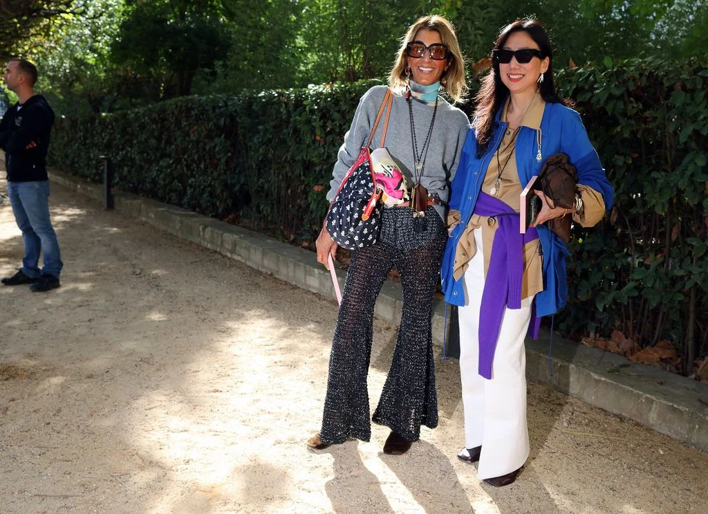 Image may contain Maggie Wei Wu Catherine Fulop Clothing Pants Accessories Bag Handbag Sunglasses Coat and Adult