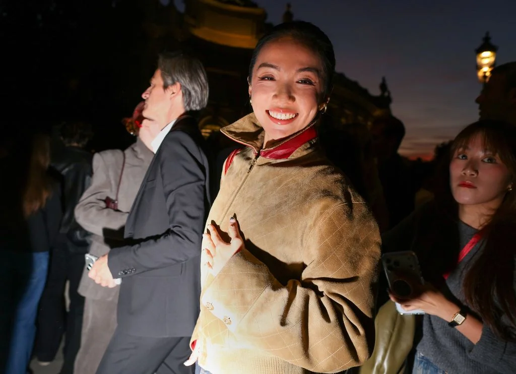 Image may contain Clothing Coat Jacket Blazer Formal Wear Suit Head Person Face Photography Portrait and Happy
