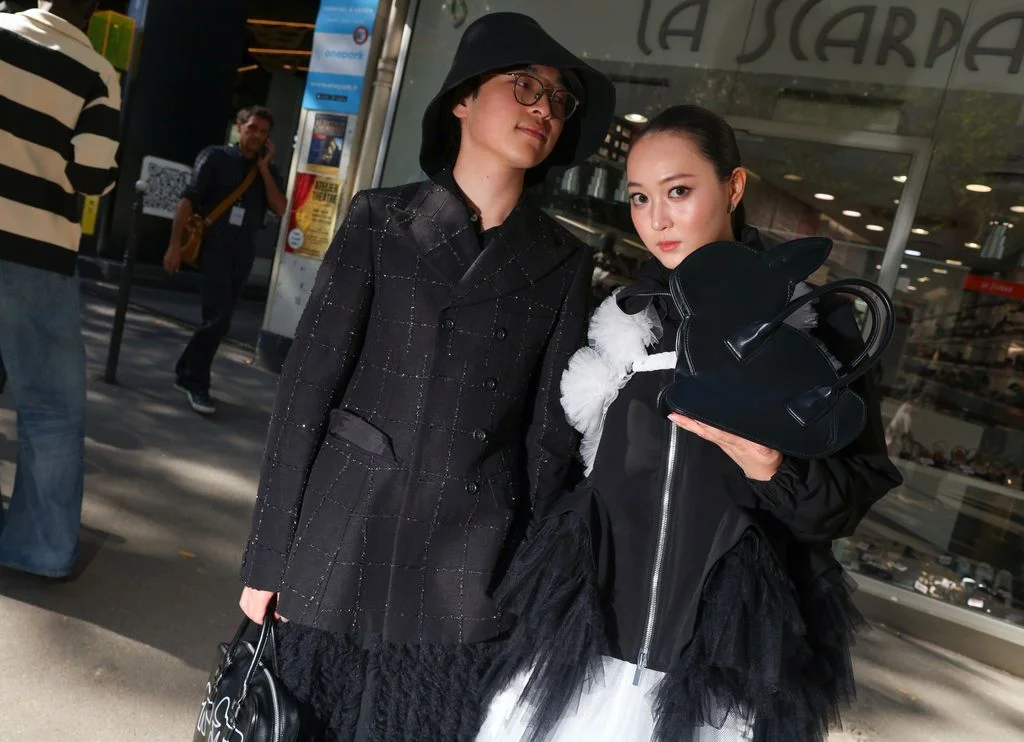 Image may contain Miyu Yoshimoto Clothing Coat Jacket Adult Person Accessories Bag Handbag Glasses and Hat