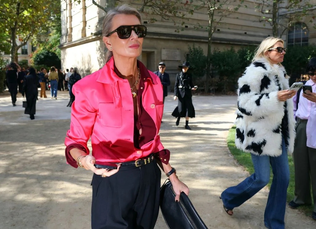 Image may contain Clothing Pants Accessories Bag Handbag Blazer Coat Jacket Person Walking Face and Head