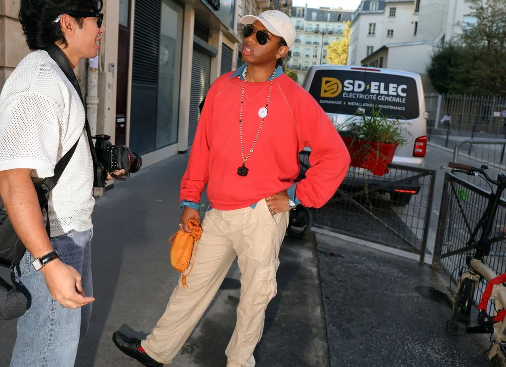 Image may contain Clothing Pants Baseball Cap Cap Hat Sleeve Accessories Person Standing Adult Footwear and Shoe