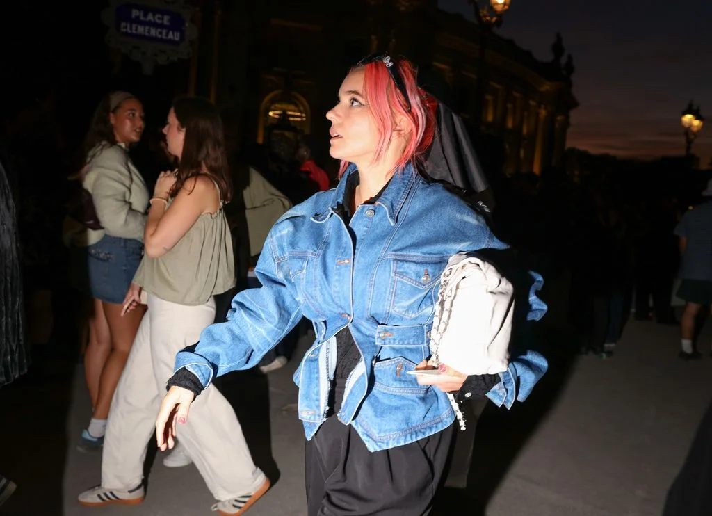 Image may contain Adult Person Clothing Pants Hair Coat Jacket Footwear Shoe Face and Head