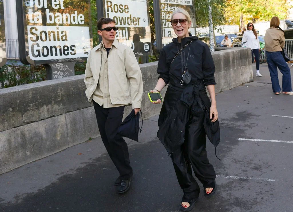 Image may contain Marshall Allman Pedestrian Person Adult Clothing Coat Accessories Bag Handbag and Glasses