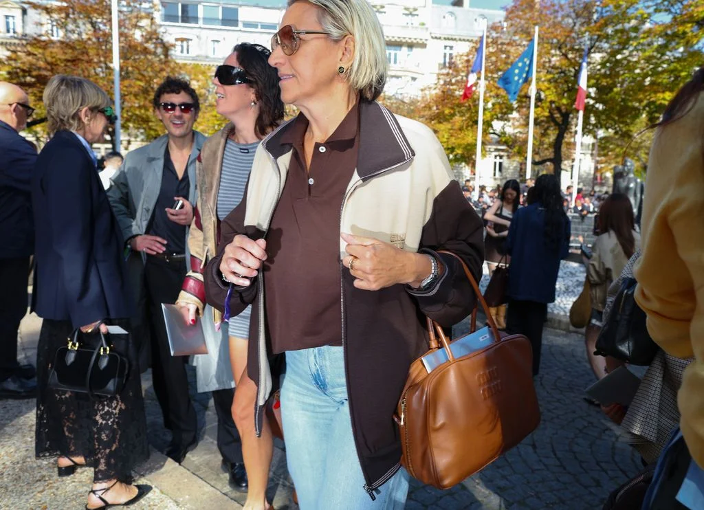Image may contain Accessories Bag Handbag Purse Adult Person Walking Clothing Pants Sunglasses Coat and Jacket