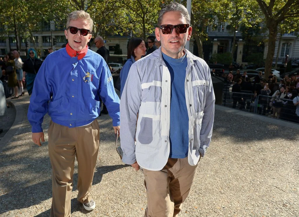 Image may contain Accessories Sunglasses Clothing Pants Shirt Person Walking Face Head Photography and Portrait