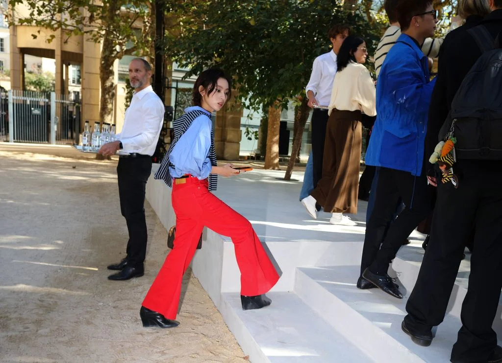 Image may contain Matthew Chapman Keiko Agena Clothing Pants Footwear Shoe Person Walking Adult Teen and Shirt