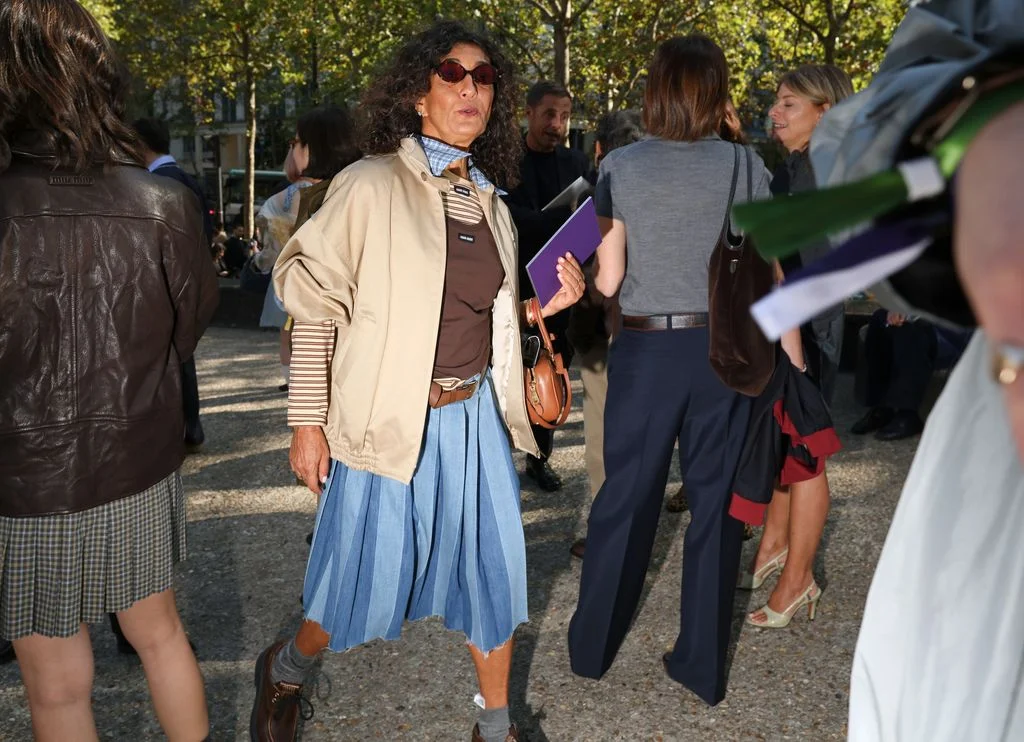 Image may contain Clothing Skirt Accessories Bag Handbag Sunglasses Adult Person Pants Walking Coat and Footwear