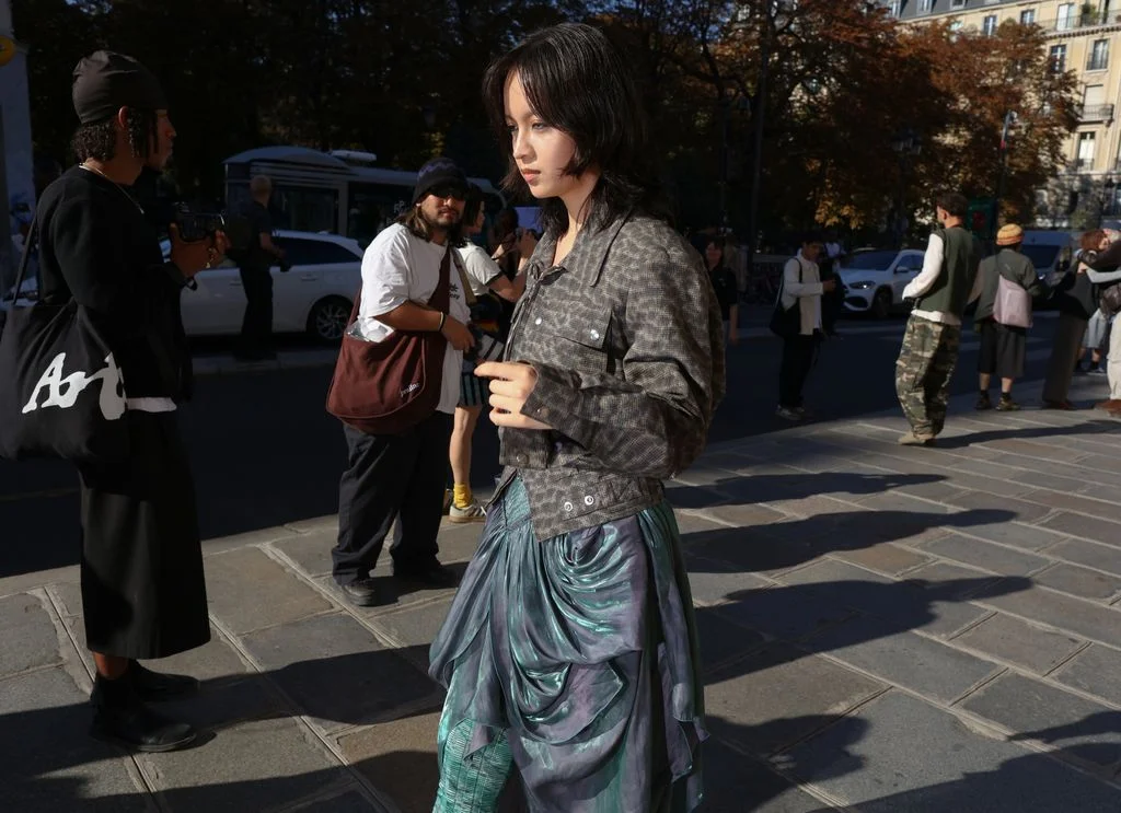 Image may contain Gigi Leung King Kapisi Accessories Bag Handbag Adult Person Black Hair Hair Clothing and Skirt
