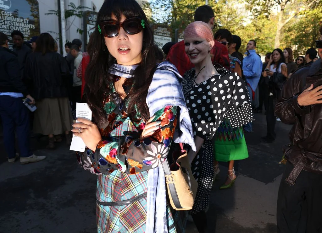 Image may contain Susanna Lau Clothing Costume Person Accessories Bag Handbag Face Head Photography and Portrait