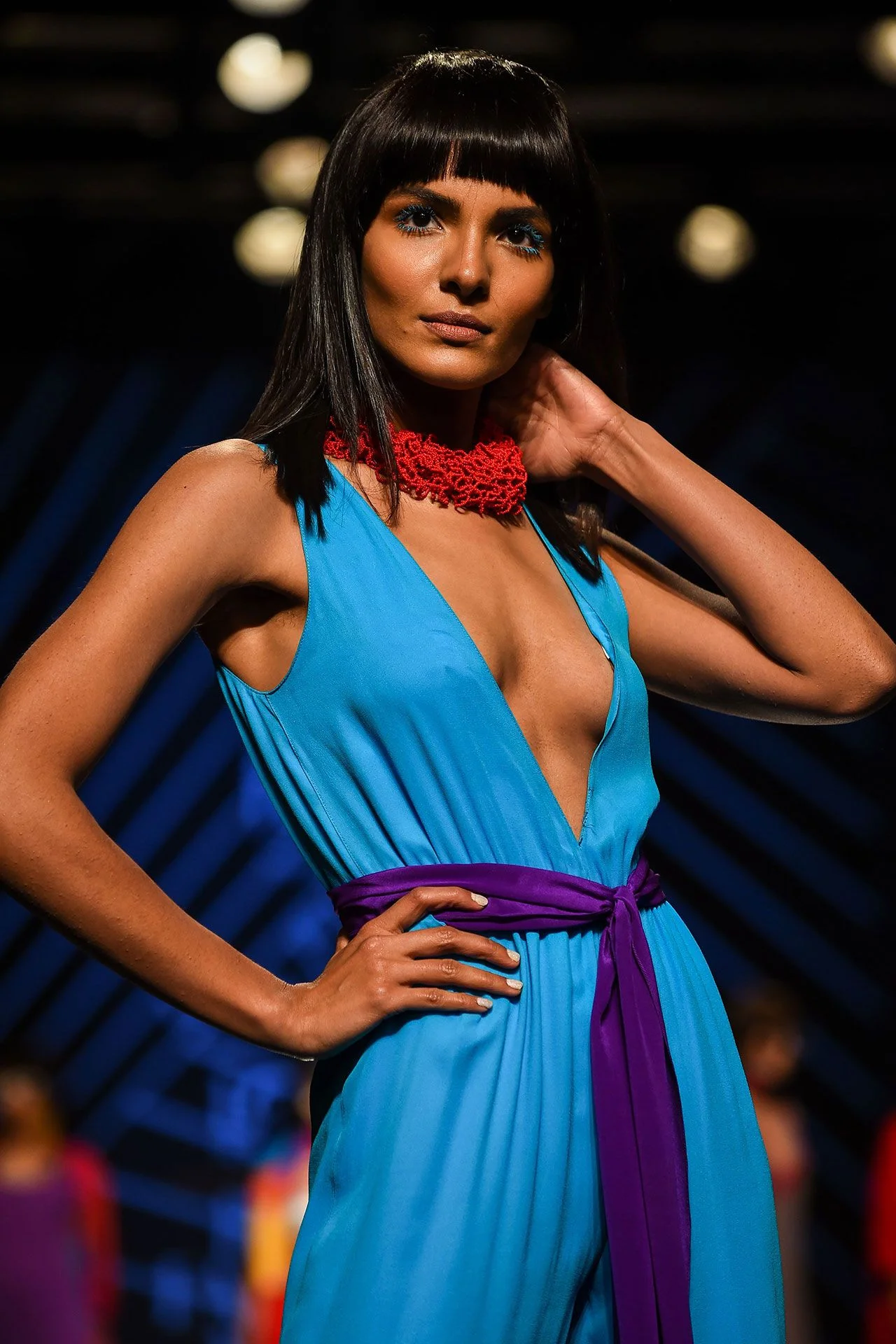 Image may contain Fashion Adult Person Clothing Dress Formal Wear Black Hair Hair Evening Dress and Accessories