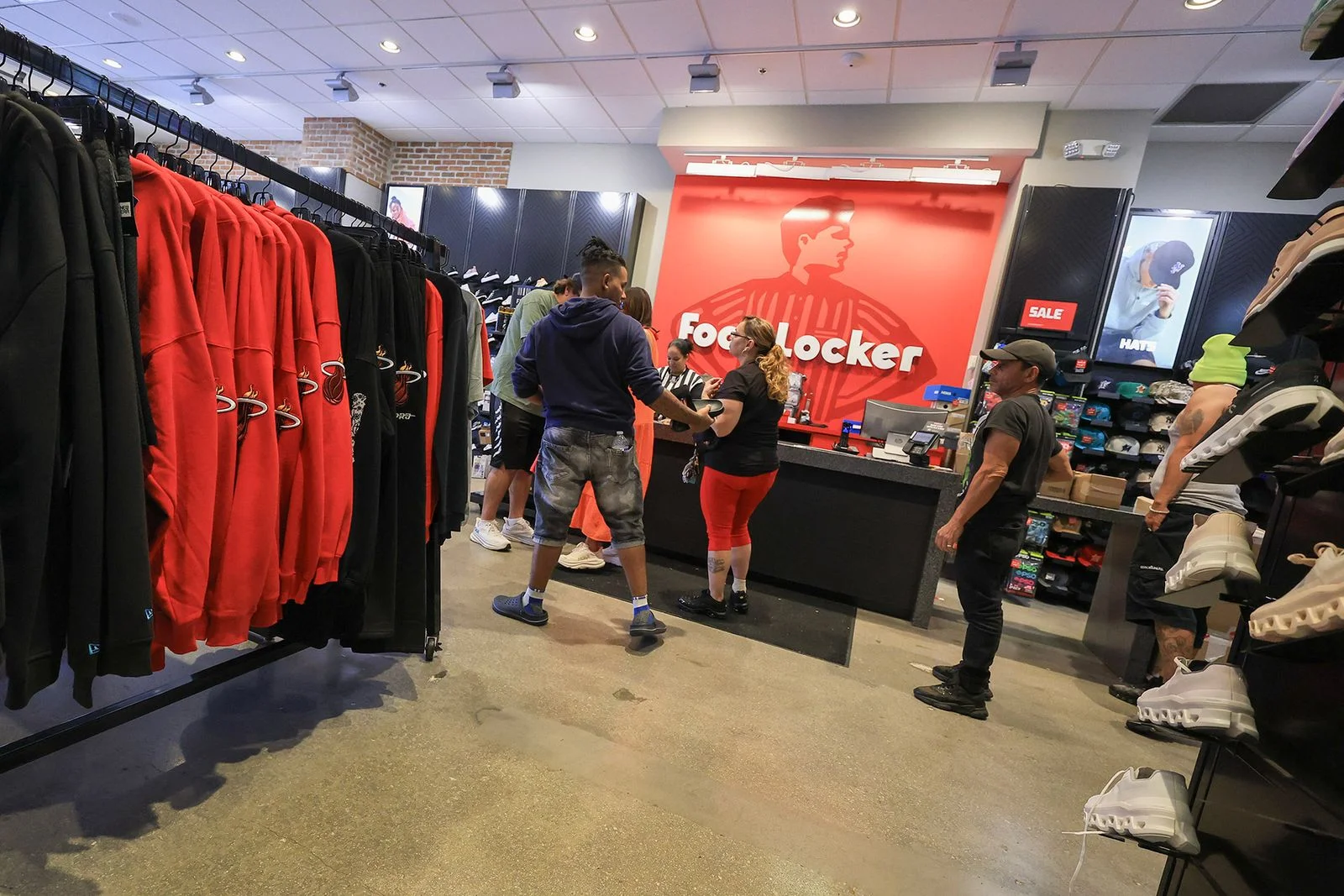 Image may contain Adult Person Clothing Footwear Shoe Hat Shop Indoors Lamp Computer Hardware and Electronics