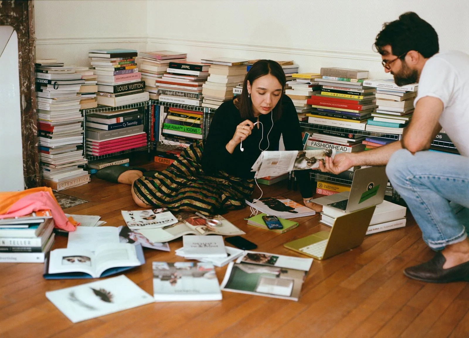 Image may contain Adult Person Reading Book Indoors Library Publication Computer Electronics Laptop and Pc