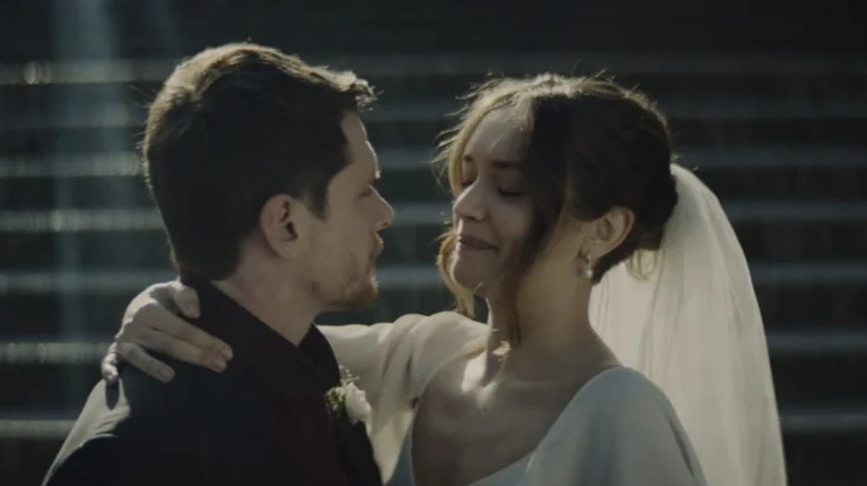 Jack O'Connell's Jude Williams holds Olivia Cooke's Emma Ryerson on a set of stairs outdoors in Little Fish