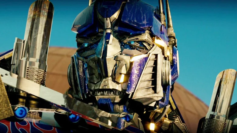 Peter Cullen as the voice of Optimus Prime glaring with purple eyes in Transformers: The Last Knight